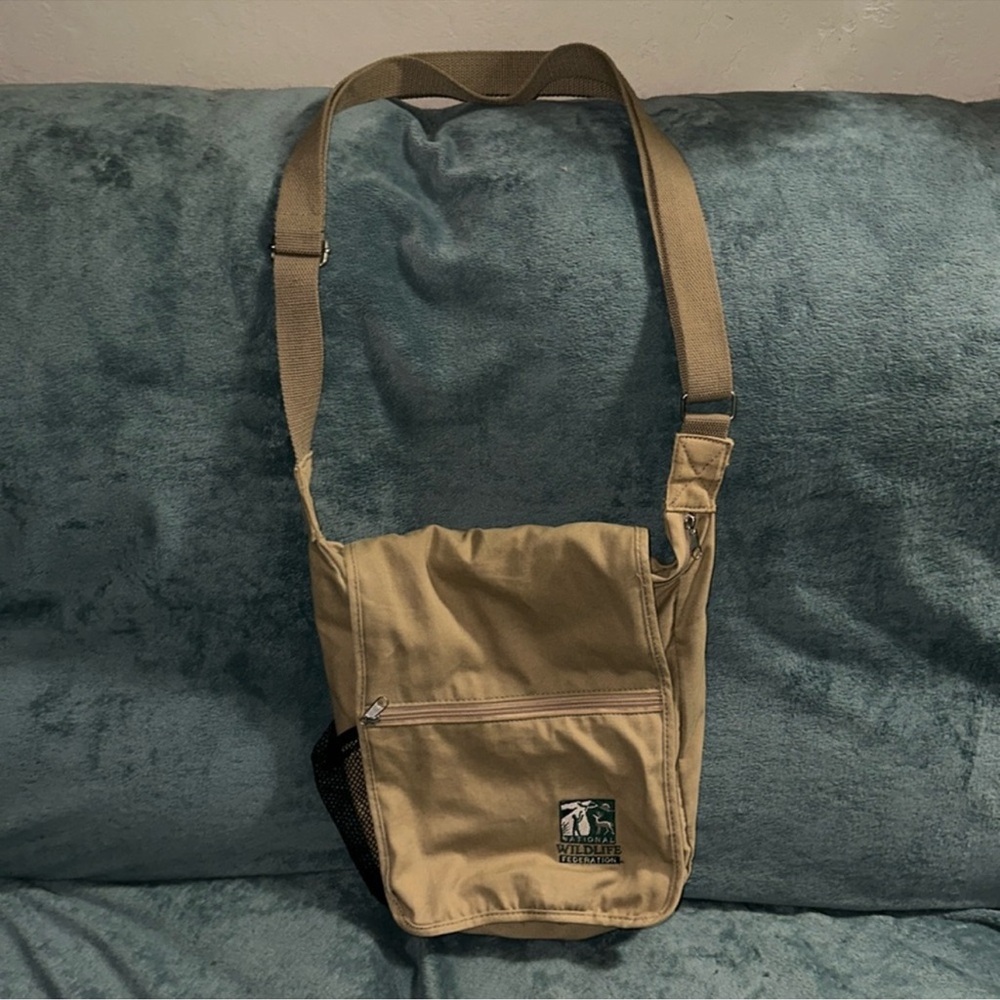 National wildlife federation tan black green white Khaki sling pack damaged